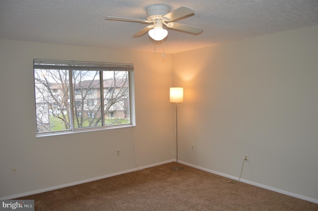 empty room featuring carpet flooring, a textured ceiling, and ceiling fan