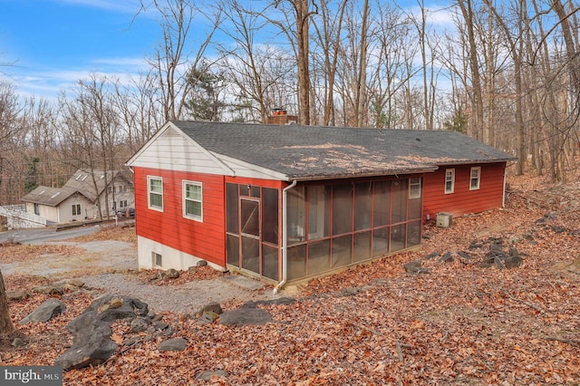 view of outdoor structure with a sunroom