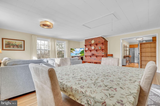 dining area featuring light hardwood / wood-style floors and ornamental molding