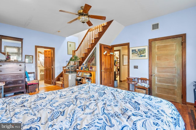 bedroom featuring ceiling fan, hardwood / wood-style floors, and ensuite bathroom