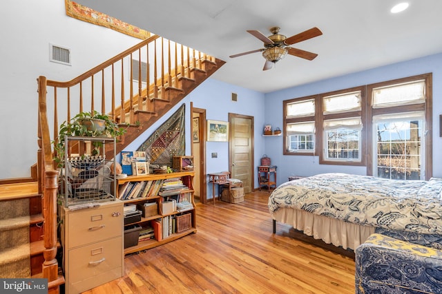 bedroom with ceiling fan and light hardwood / wood-style floors