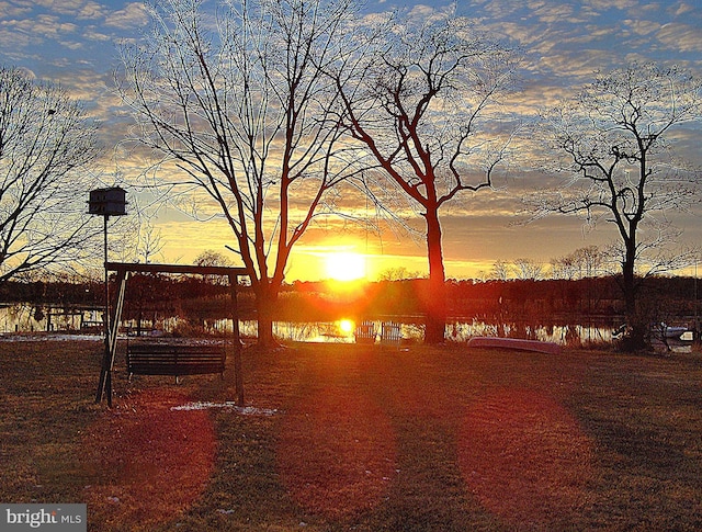 yard at dusk with a water view