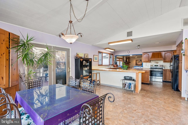 dining area featuring lofted ceiling