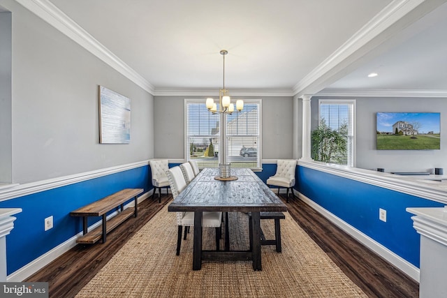 dining space with plenty of natural light, ornamental molding, dark wood-type flooring, and a chandelier