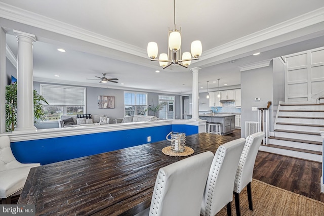 dining room with dark hardwood / wood-style flooring, ceiling fan with notable chandelier, ornamental molding, and sink