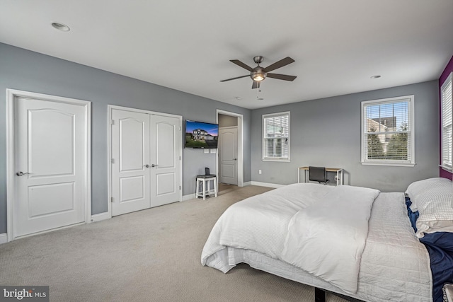 bedroom with light carpet and ceiling fan