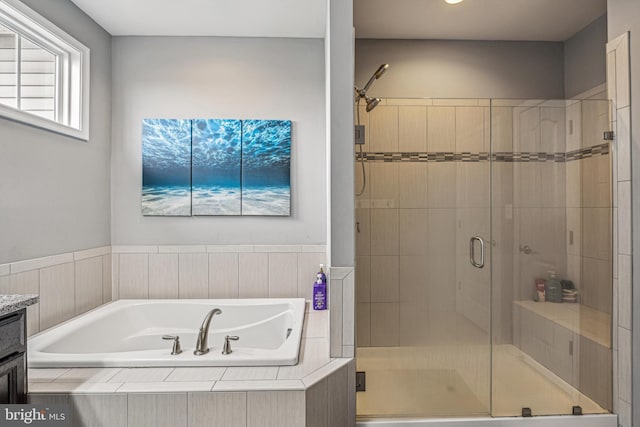 bathroom featuring separate shower and tub and vanity