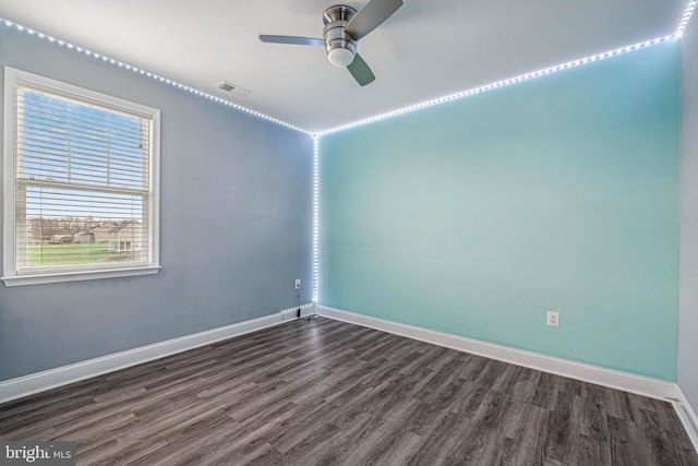 spare room featuring ceiling fan and dark wood-type flooring