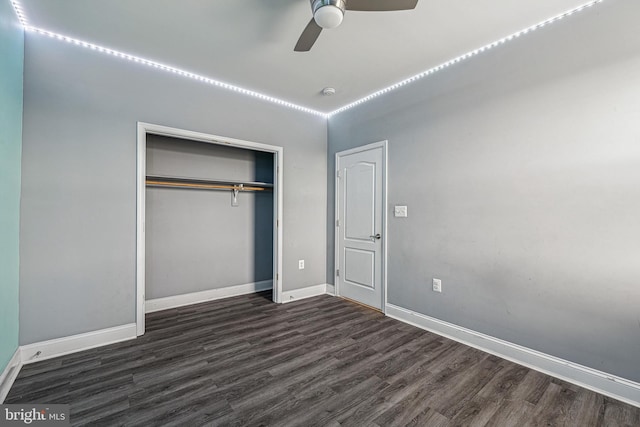 unfurnished bedroom with ceiling fan, a closet, and dark wood-type flooring