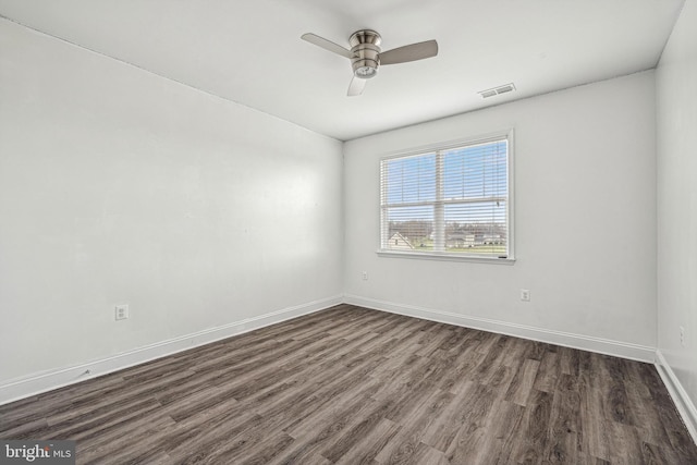 unfurnished room featuring dark hardwood / wood-style floors and ceiling fan