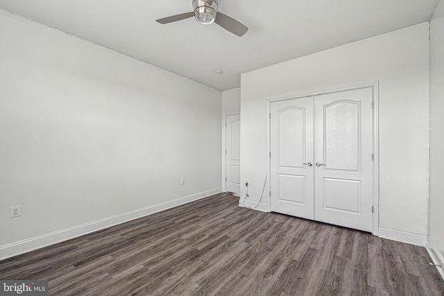 unfurnished bedroom with a closet, ceiling fan, and dark hardwood / wood-style floors