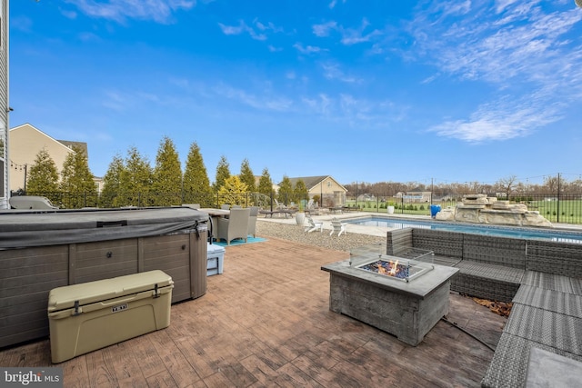 view of patio with a fire pit and a fenced in pool