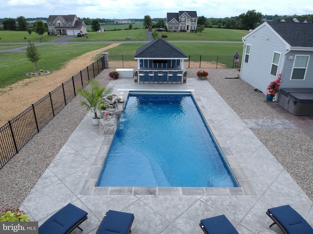 view of pool with pool water feature, a patio, and an outdoor structure