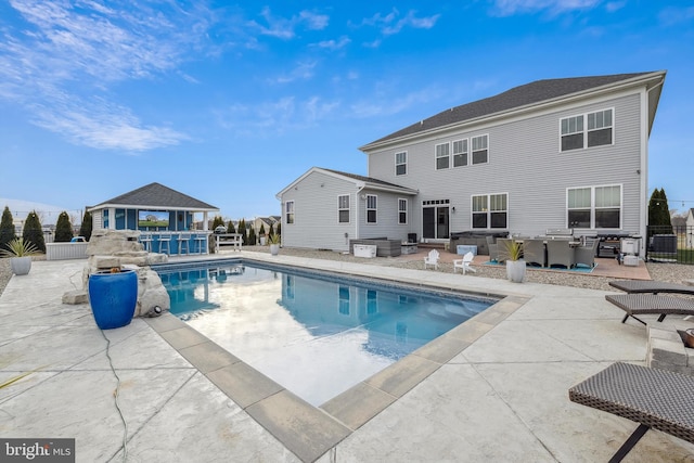 view of pool featuring a gazebo, a patio area, and a bar