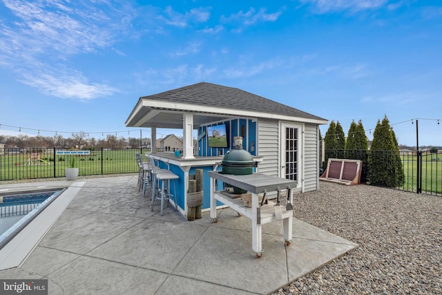 view of patio / terrace with a fenced in pool and an outdoor bar