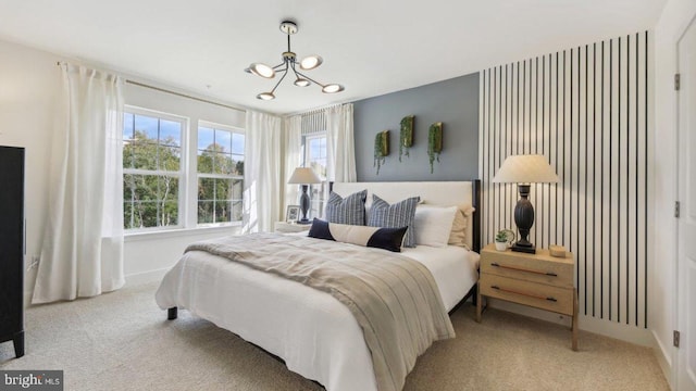 carpeted bedroom with a notable chandelier