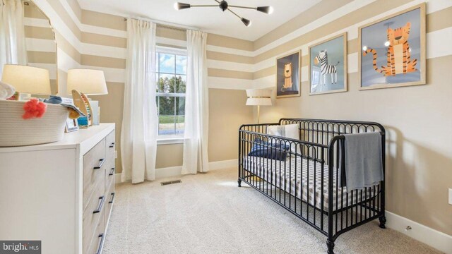 carpeted bedroom with a nursery area