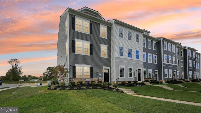 view of property featuring a lawn