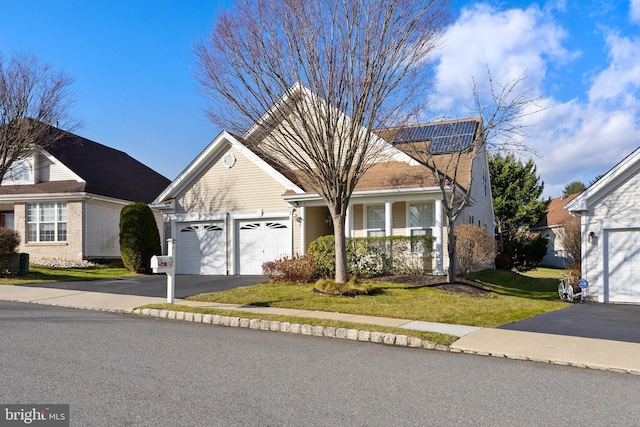 view of front property featuring a garage and a front lawn