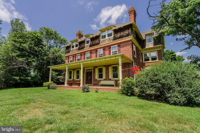 view of front of property with a porch and a front yard