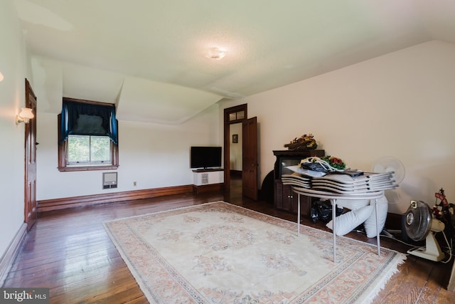 interior space with dark hardwood / wood-style floors and vaulted ceiling