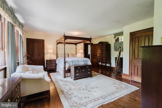 bedroom featuring dark wood-type flooring and a textured ceiling