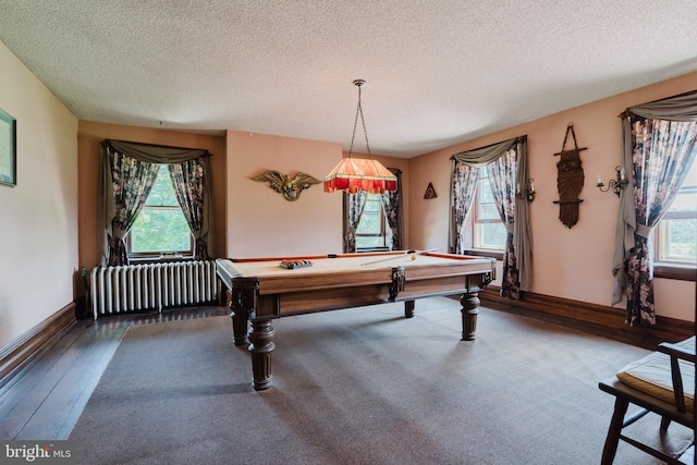 playroom featuring radiator heating unit, a healthy amount of sunlight, a textured ceiling, and billiards