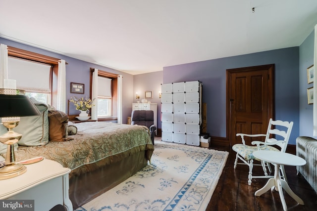 bedroom featuring hardwood / wood-style floors and radiator heating unit