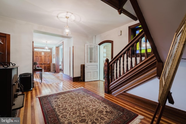 entryway featuring wood-type flooring and a notable chandelier