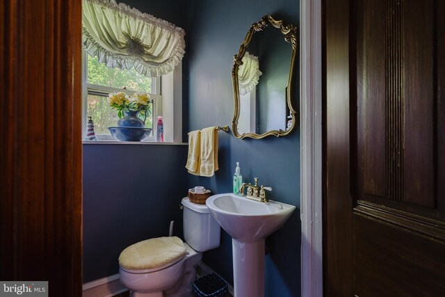 bathroom featuring toilet and a baseboard heating unit