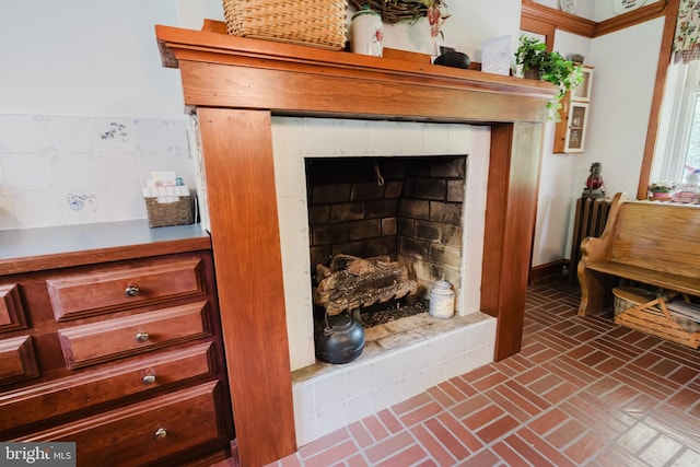 details with a tile fireplace