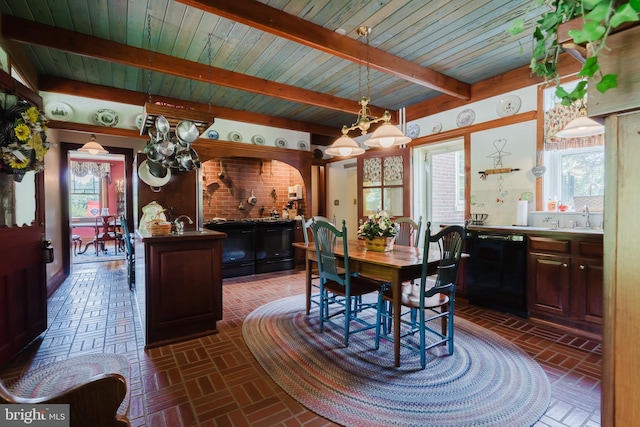 dining space with beamed ceiling, sink, and an inviting chandelier