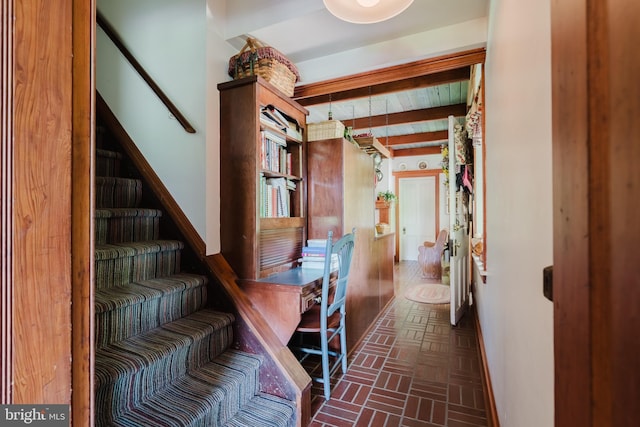 hallway featuring beam ceiling