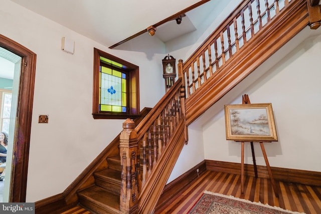 stairs featuring a healthy amount of sunlight and wood-type flooring