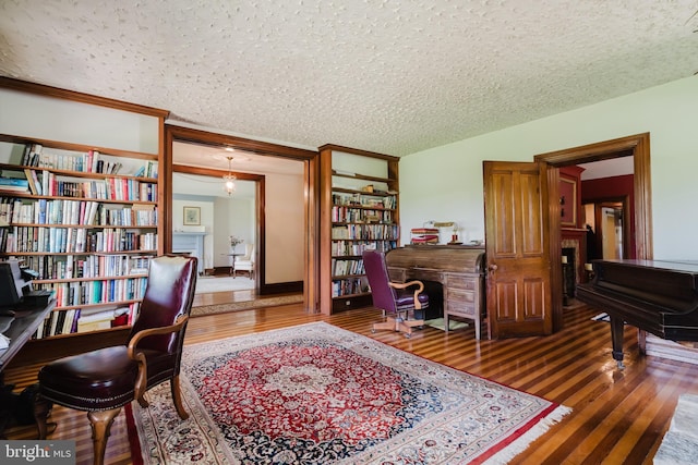 office space with dark hardwood / wood-style flooring and a textured ceiling