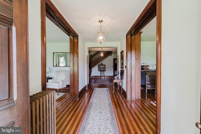 hall featuring dark hardwood / wood-style flooring and radiator heating unit