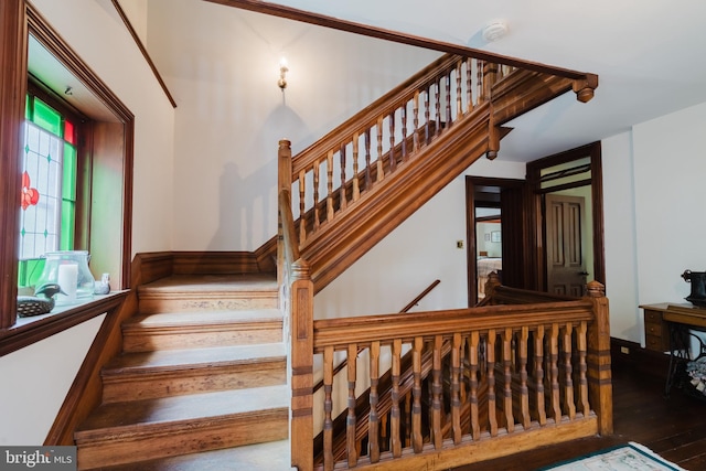 stairs with hardwood / wood-style flooring