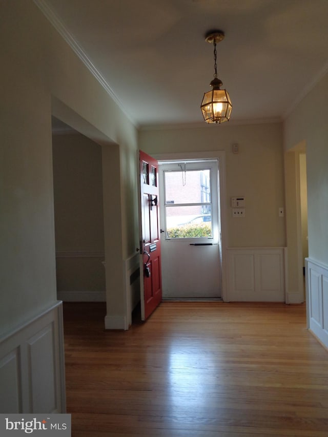 interior space featuring hardwood / wood-style floors and ornamental molding