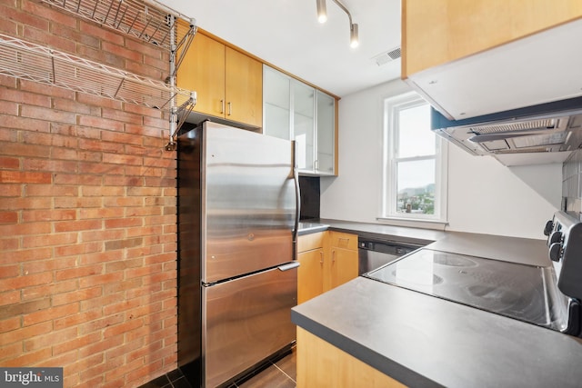 kitchen with exhaust hood, light tile patterned floors, stainless steel appliances, and brick wall