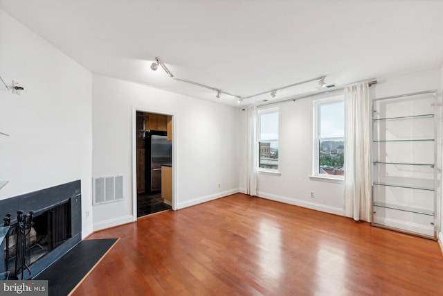 unfurnished living room featuring hardwood / wood-style flooring