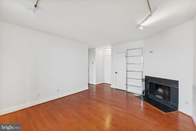 unfurnished living room with wood-type flooring