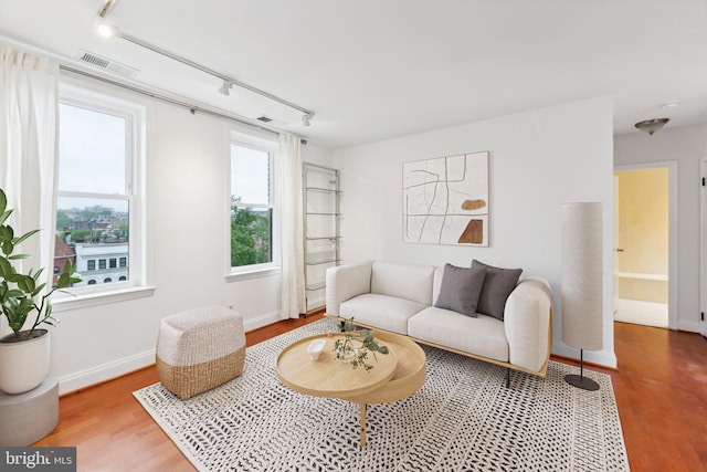 living room featuring hardwood / wood-style floors and track lighting