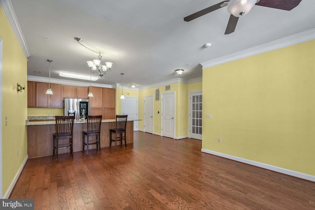 kitchen featuring pendant lighting, stainless steel refrigerator with ice dispenser, and ornamental molding