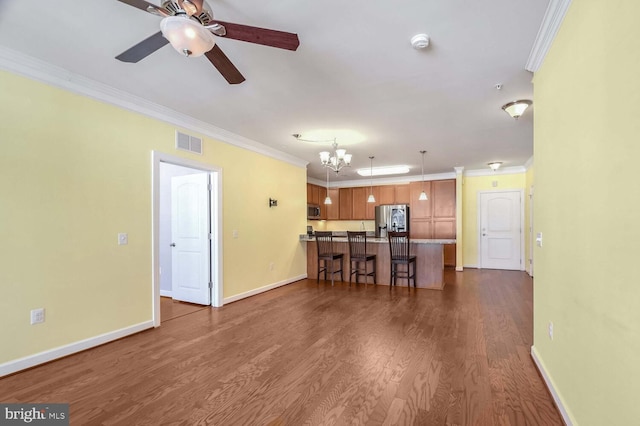 unfurnished living room with ceiling fan with notable chandelier, dark hardwood / wood-style flooring, and crown molding