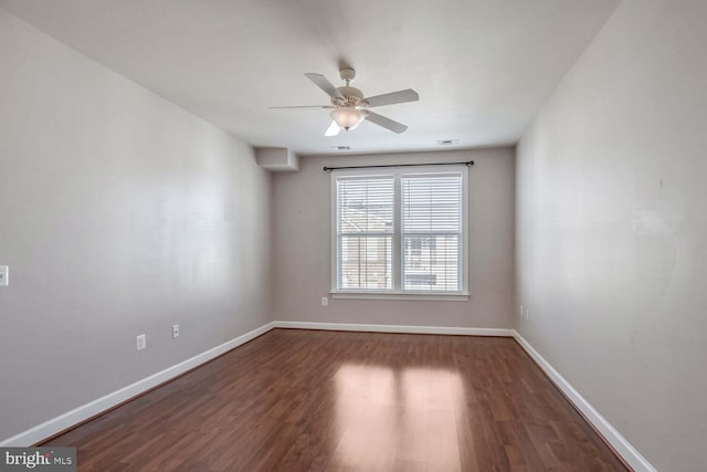 unfurnished room with ceiling fan and dark wood-type flooring