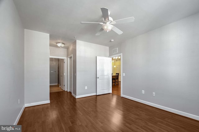 unfurnished bedroom with ceiling fan and dark wood-type flooring