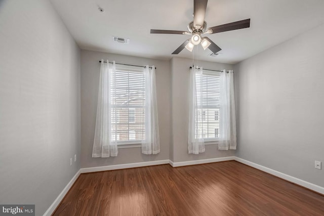 spare room featuring hardwood / wood-style flooring, ceiling fan, and a healthy amount of sunlight