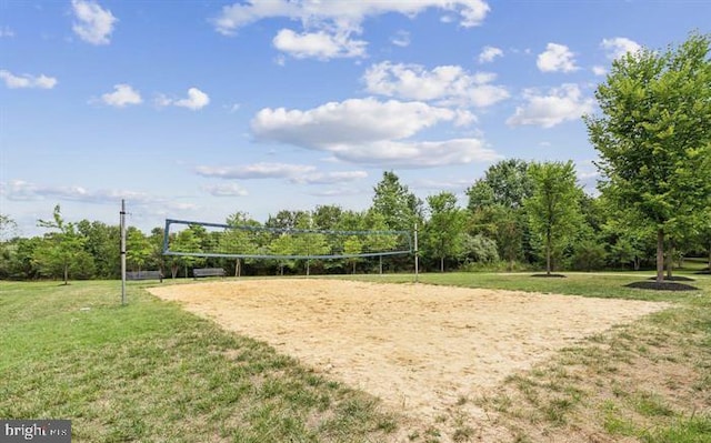 view of home's community featuring volleyball court and a yard