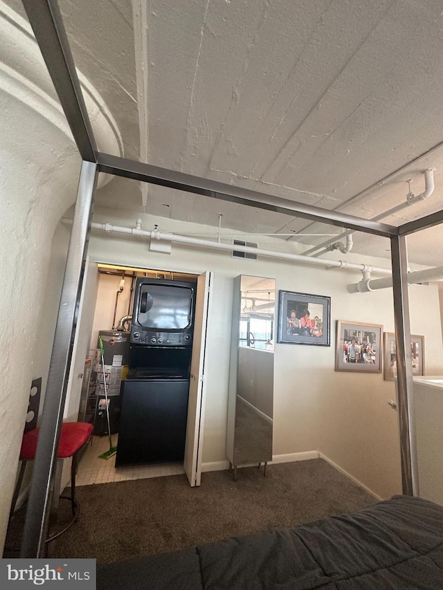 interior space featuring carpet flooring, stacked washer / drying machine, and water heater