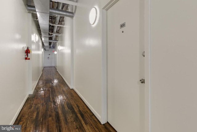 corridor with dark wood-type flooring